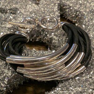 12 Strand waxed black cotton, 12 silver tubes, unique clasp